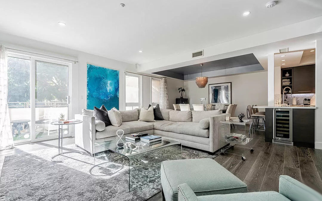 Home prices and a gorgeous living room with a white & grey color theme.