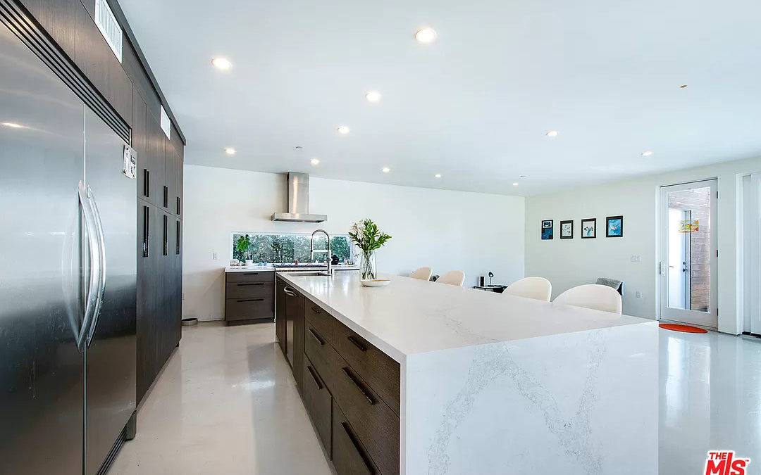 NAR and a beautiful kitchen featuring a marble island.