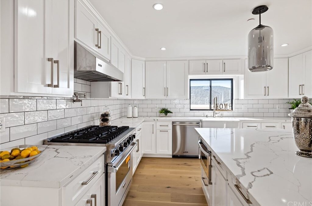 Housing Market featuring a lovely white kitchen with hardwood flooring.