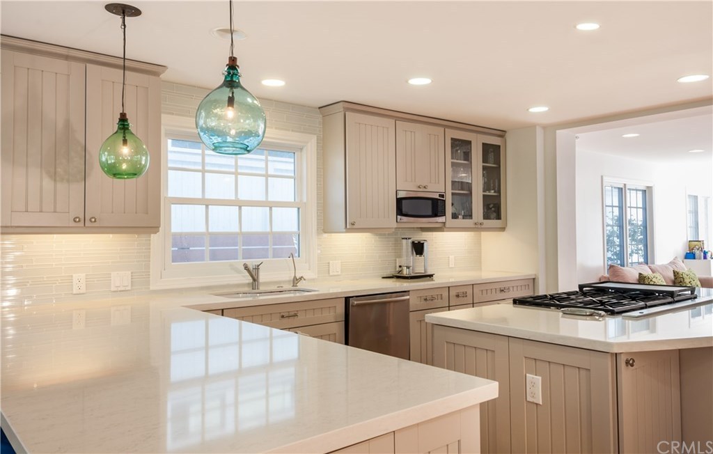 Housing market featuring a white kitchen with a marble counter top.